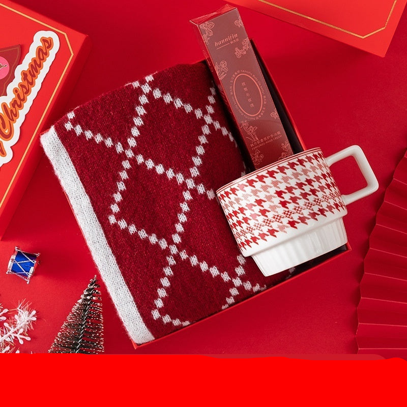 Houndstooth mug, Han Fangli hand cream, and scarf on a red background with Christmas-themed packaging.