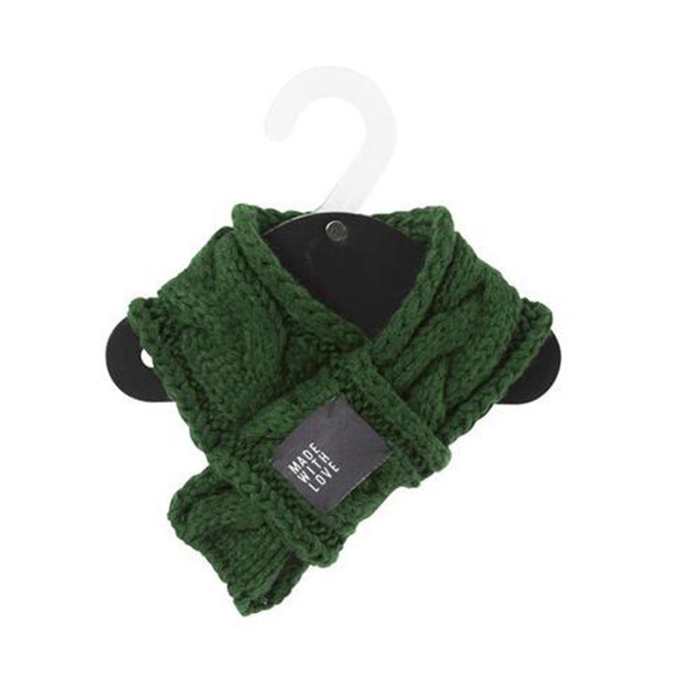 Green knitted scarf on a hanger with a visible brand tag against a white background