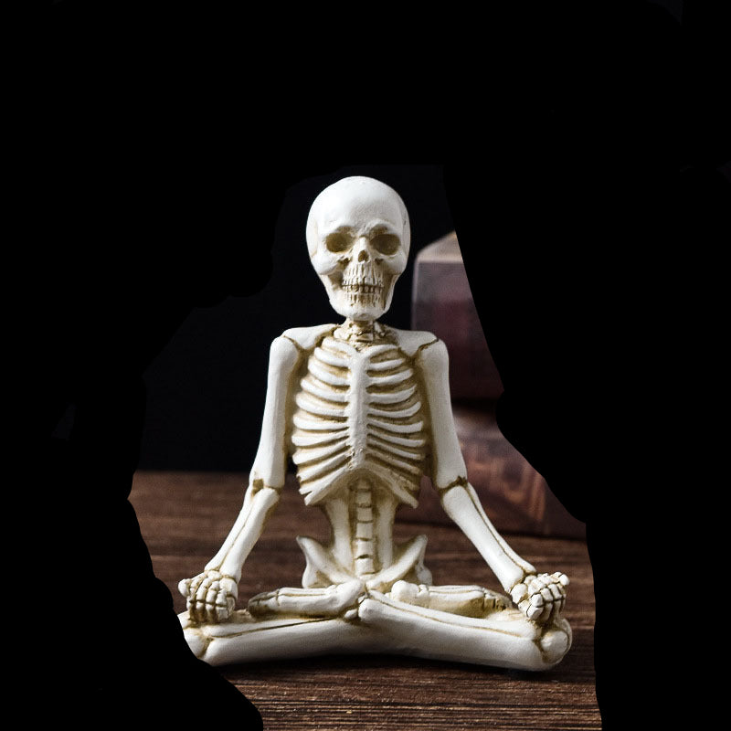 Skeletal figure in a meditative pose with measurements on a dark background
