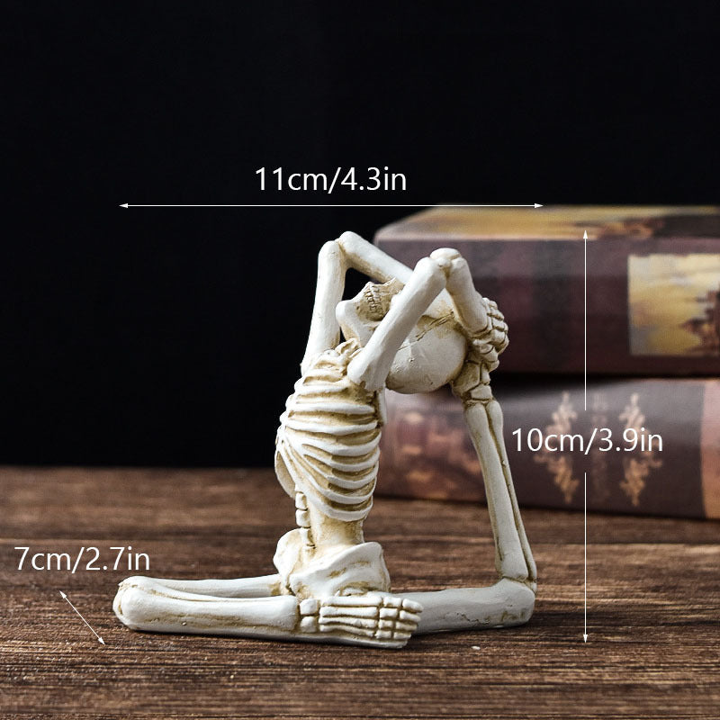 Skeletal yoga figure with measurements on a wooden surface