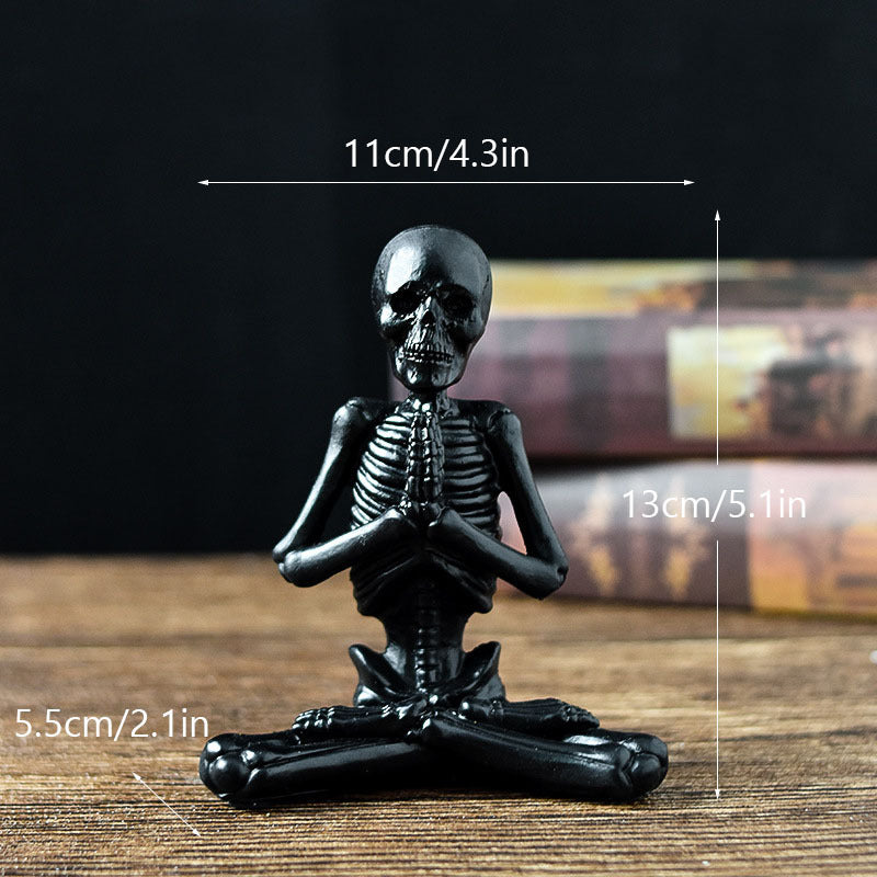 Black skeleton figurine with measurements on a wooden surface