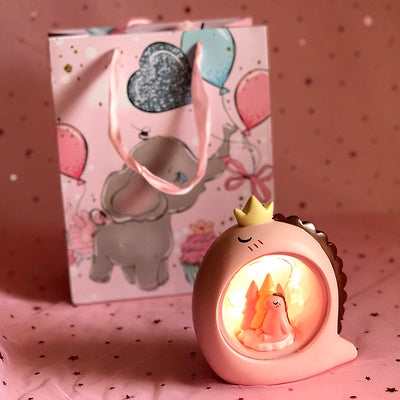 Decorative night light with a pink elephant design in the background