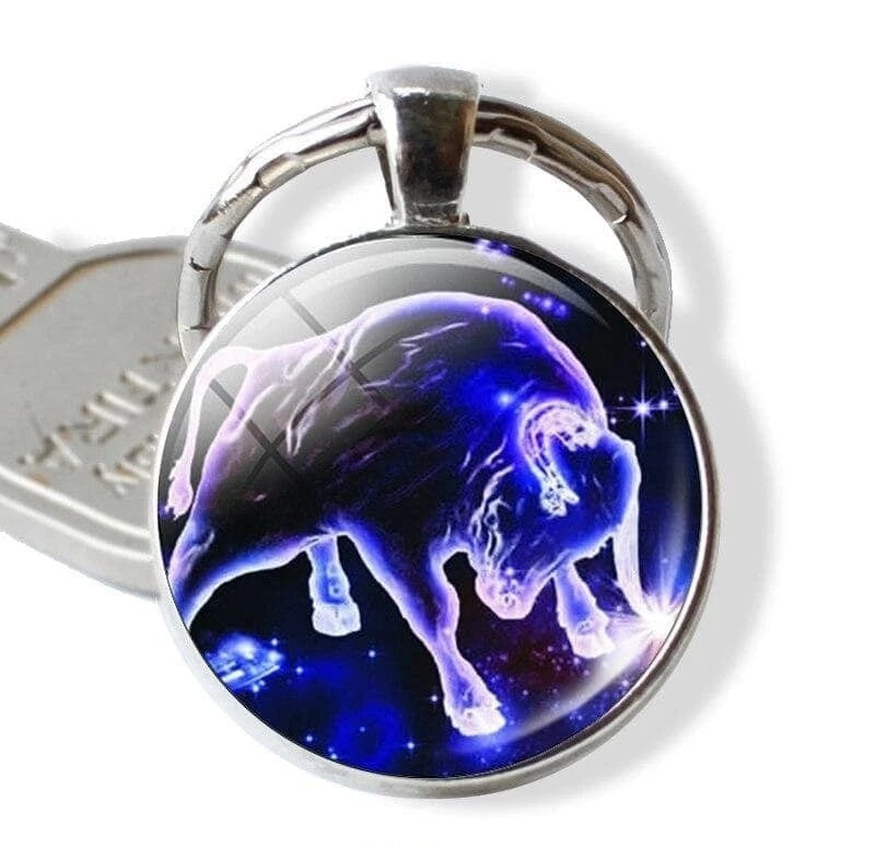 Keychain with a blue and purple lion design on a white background