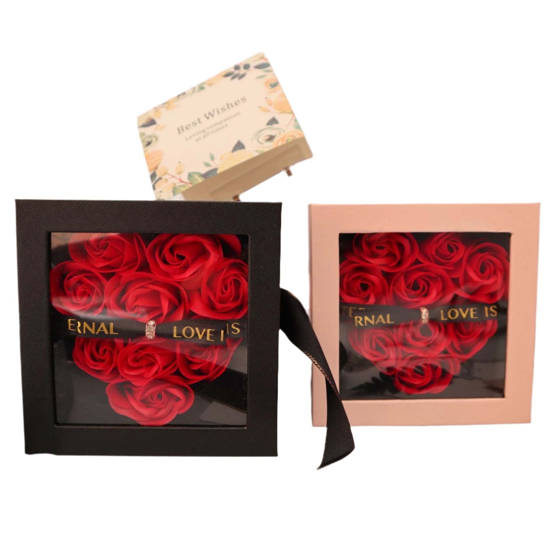 Two boxes with red roses and 'Eternal Love Is' text on a decorative surface.