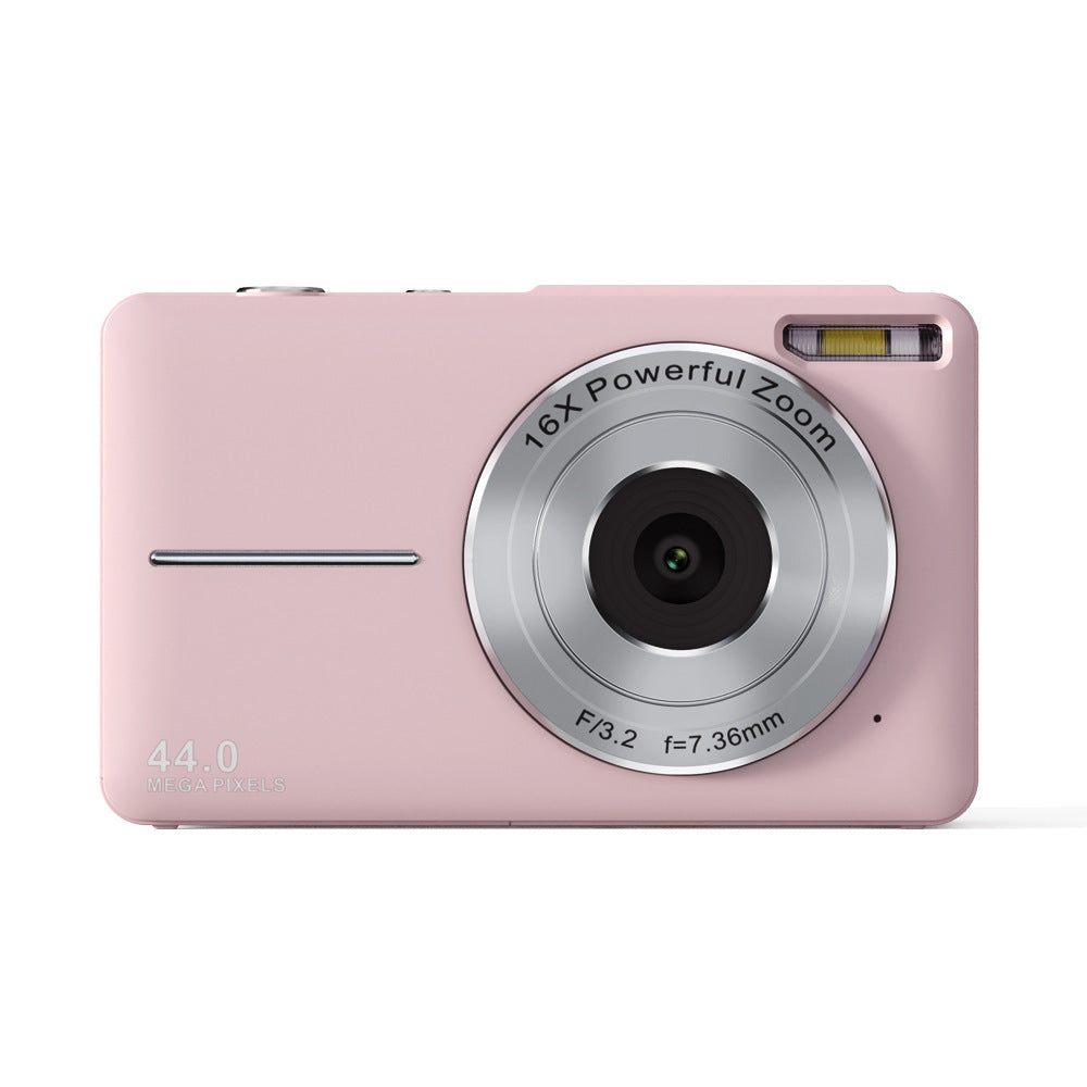 Pink digital camera with silver zoom lens on a white background