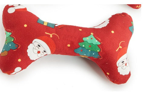 Red bone-shaped fabric toy with Christmas-themed designs on a white background