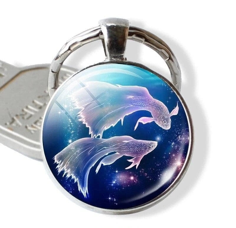 Keychain with dolphin design on a blue background, branded 'Zodiac Jewelry'.