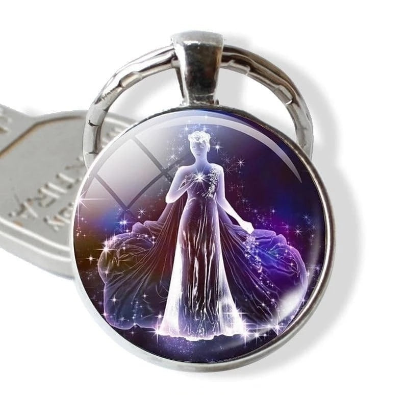 Keychain with a design of a woman in a flowing dress against a starry background, branded 'Zodiac Jewelry'.