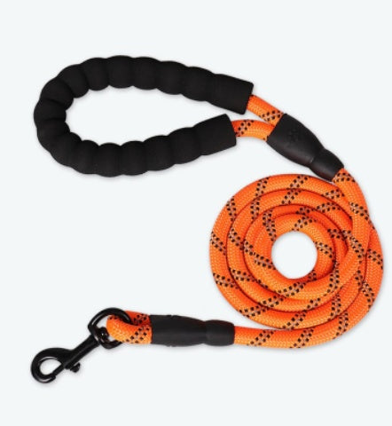 Black and orange dog leash with a clip on a white background