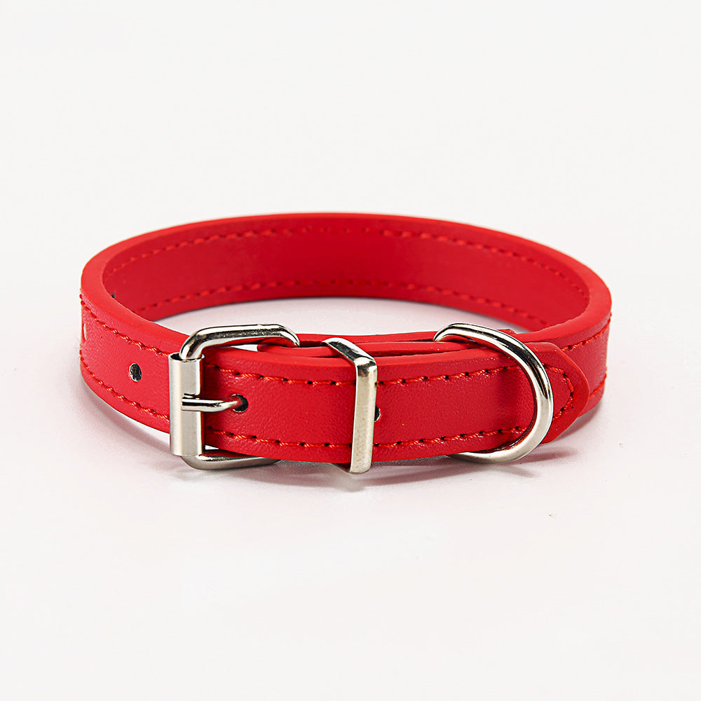 Red leather dog collar with silver buckle on a white background