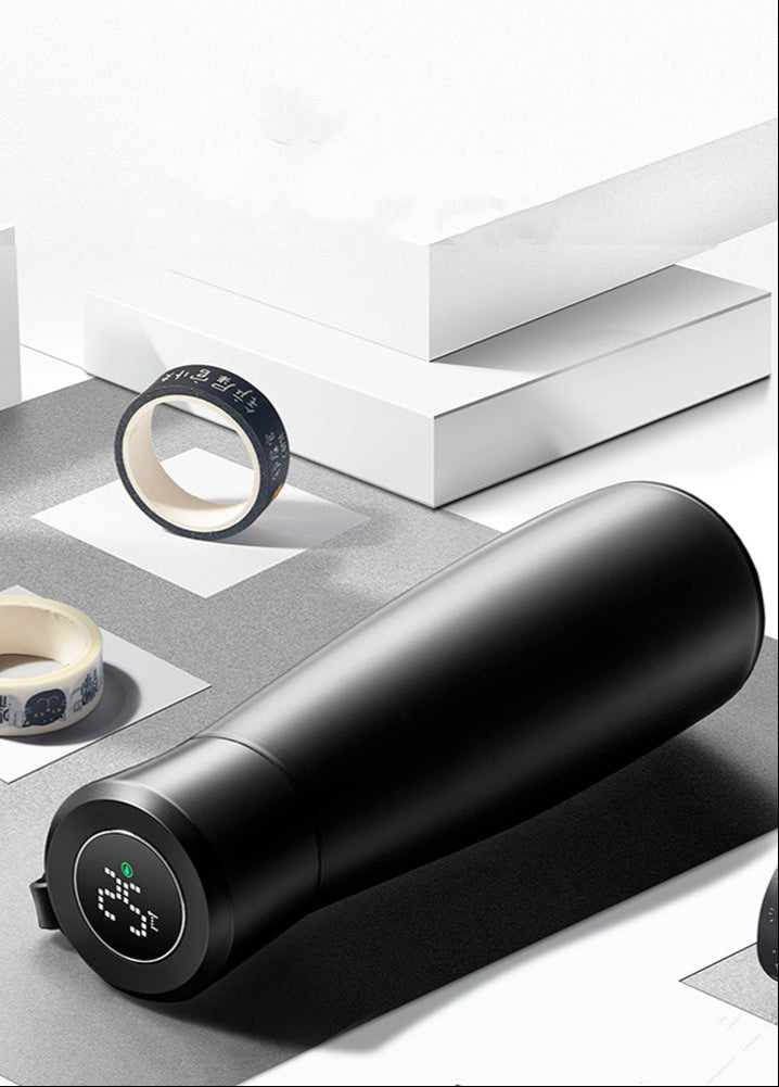 Black electronic device with digital display on a white surface