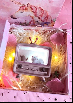 Decorative box with unicorn design and 'Guard Love Eternal' text, featuring a small TV-like device.