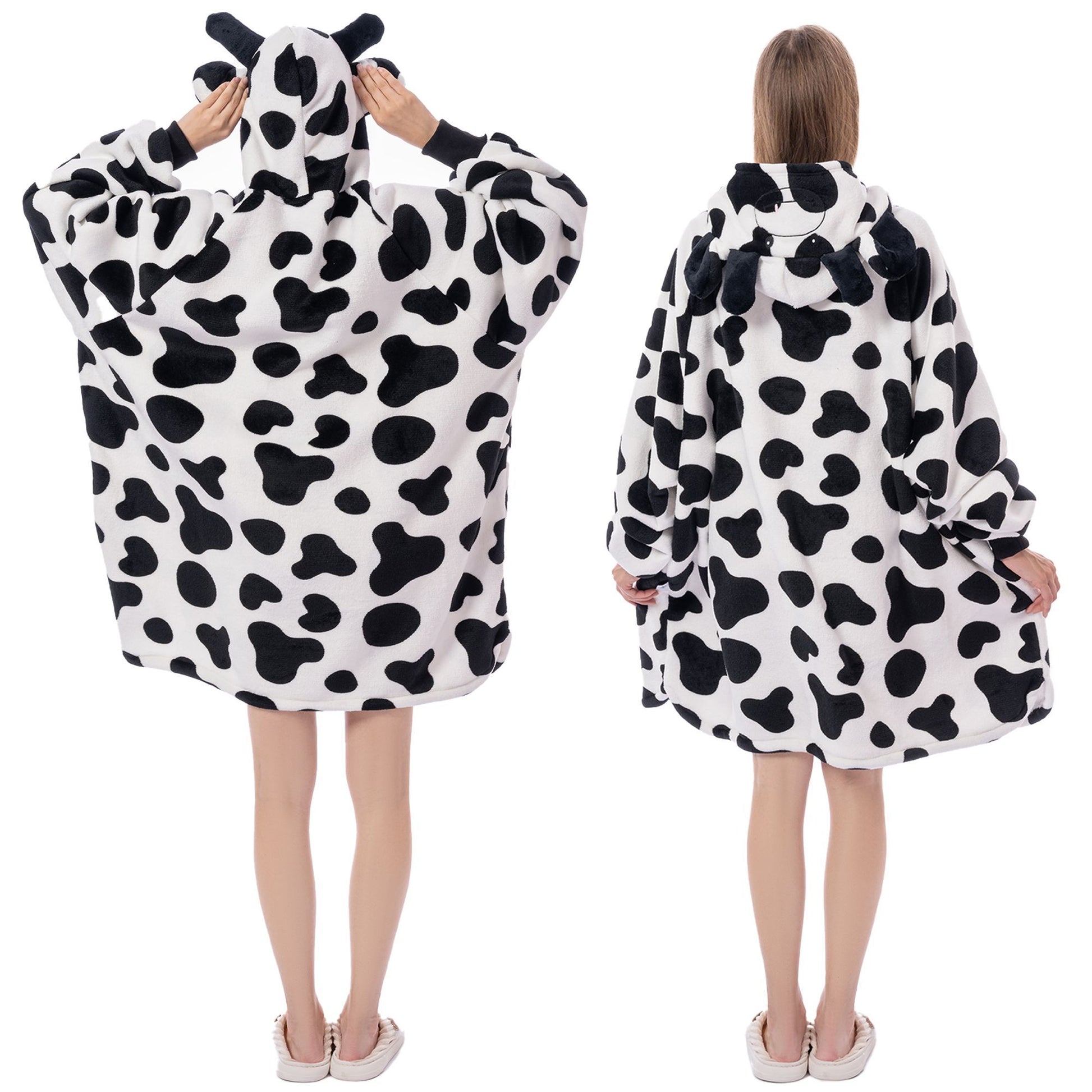 Cow print poncho worn by a person on a white background