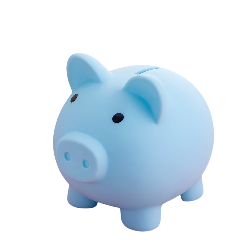 Blue piggy bank on a pink surface with a blurred background