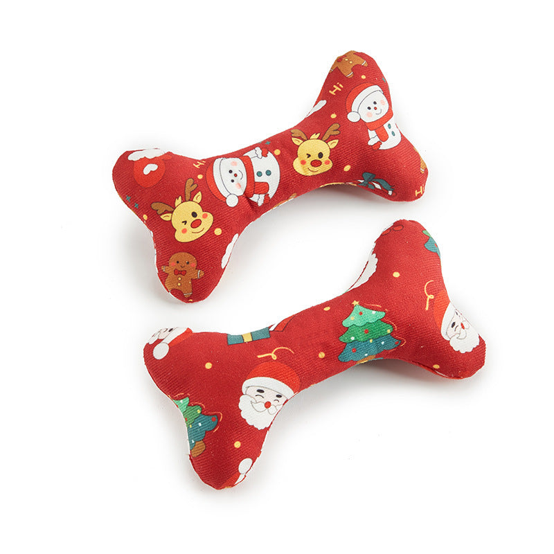 Two red bone-shaped Christmas-themed dog toys on a white background