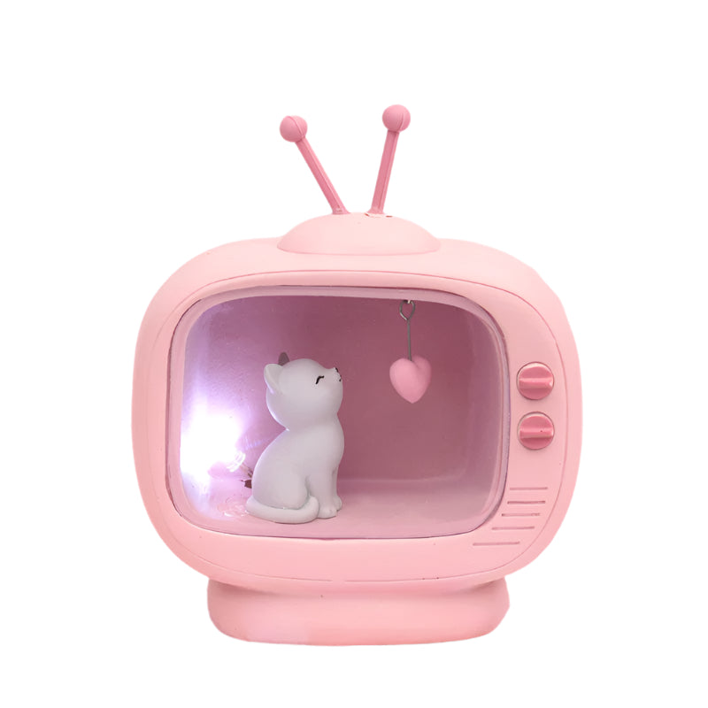 Pink vintage-style TV with a white cat figurine and heart on a soft pink background