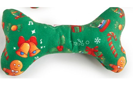 Green dog toy with festive patterns on a white background