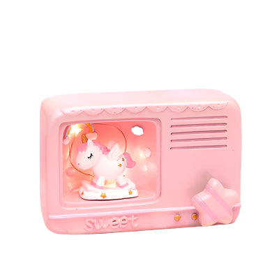 Pink electronic device with a unicorn figurine on a pink background