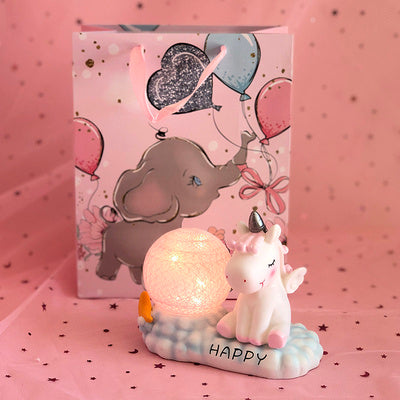 Decorative unicorn lamp with a pink background featuring balloons and an elephant.
