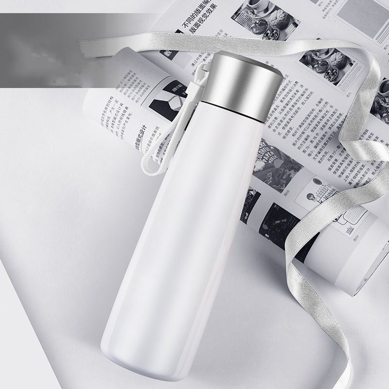 White water bottle with silver lid on a newspaper background