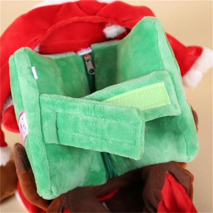 Green plush toy with a zipper on a red and brown background