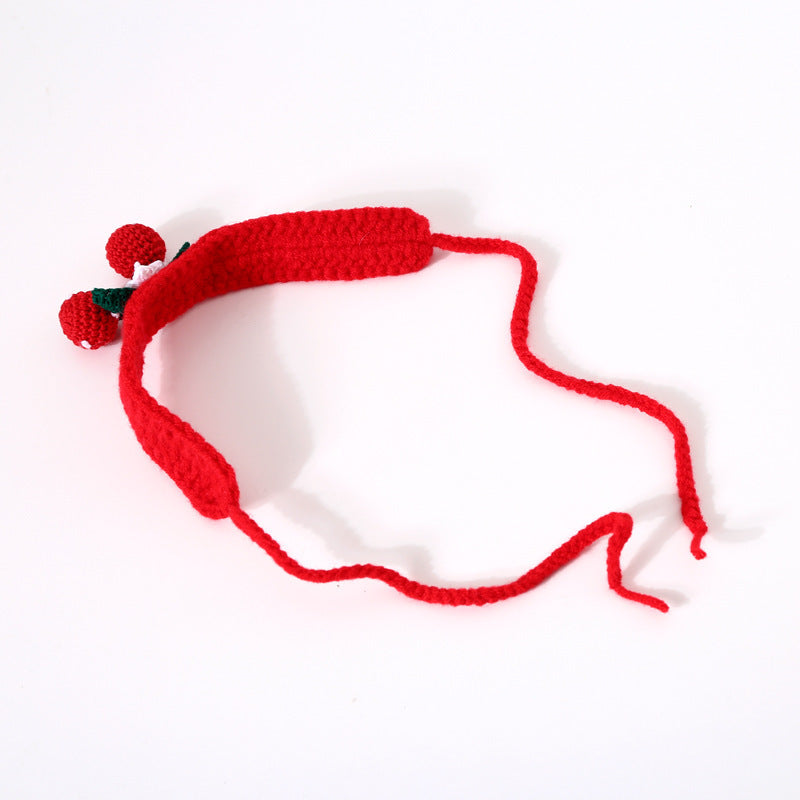 Red crocheted headband with a small decorative item on a white background