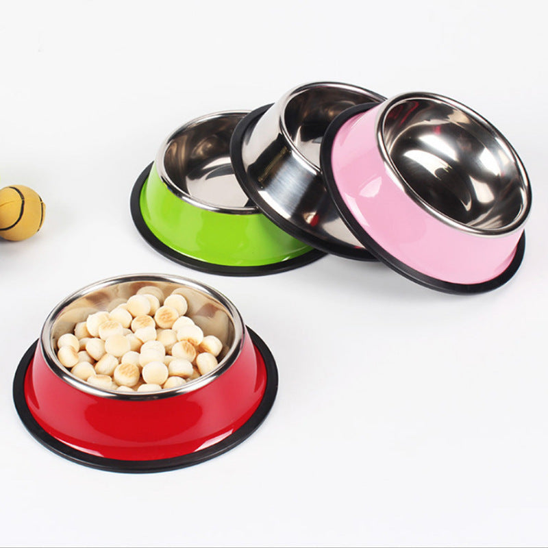 Set of colorful pet bowls with food on a white background
