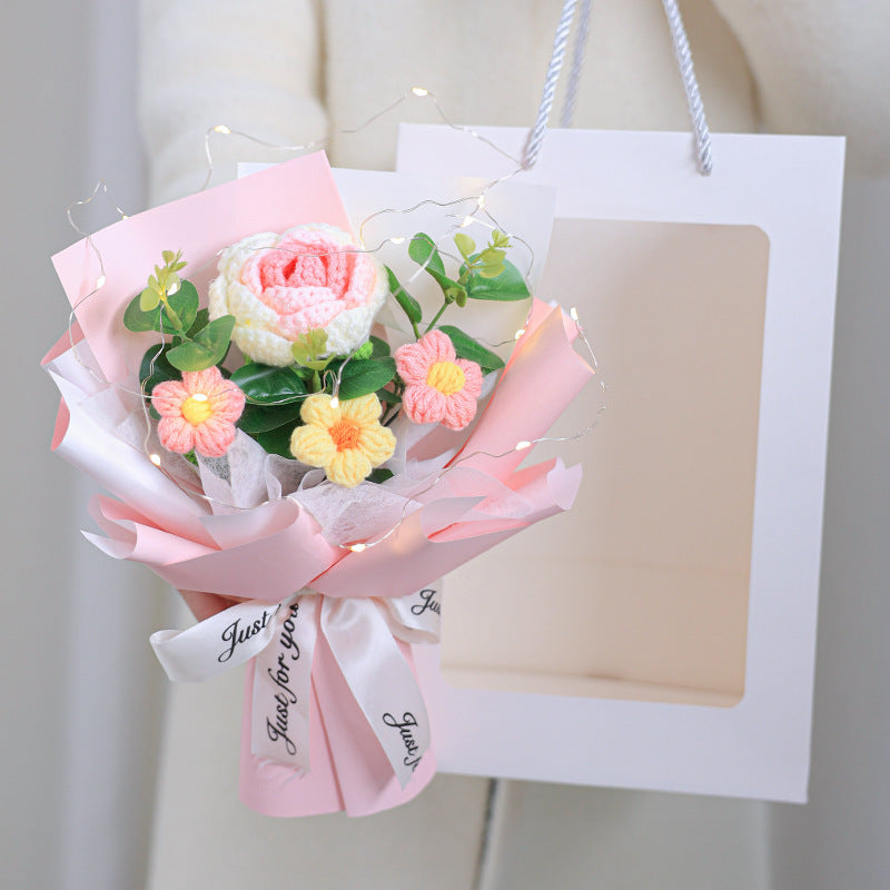 Bouquet of flowers with a white gift bag on a light background