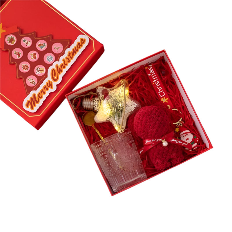 Christmas-themed gift set with decorative items in a red box on a red white background.