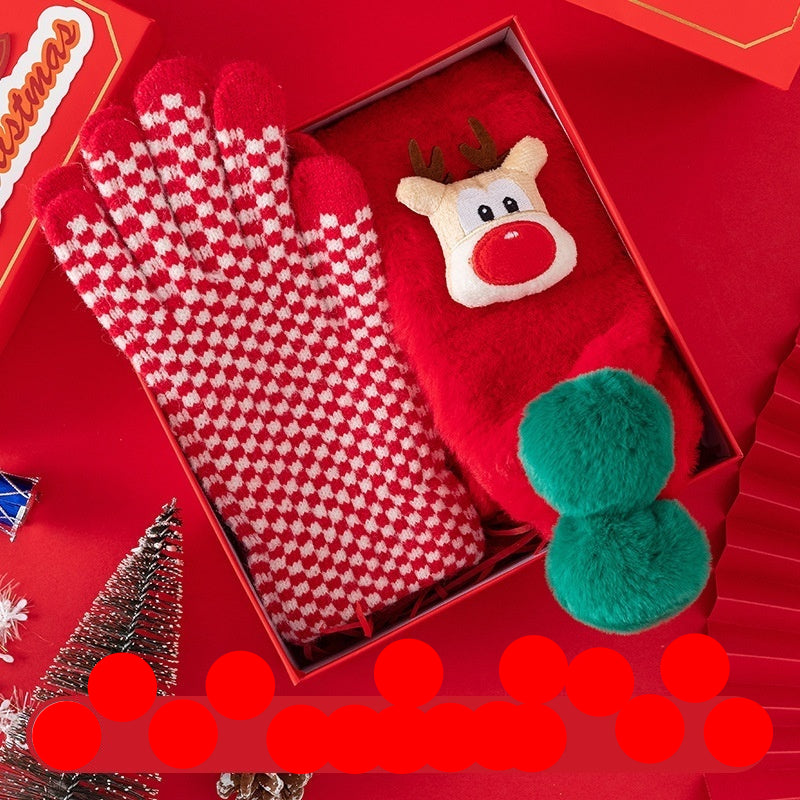 Red and white checkered scarf with gloves and a reindeer toy on a red background