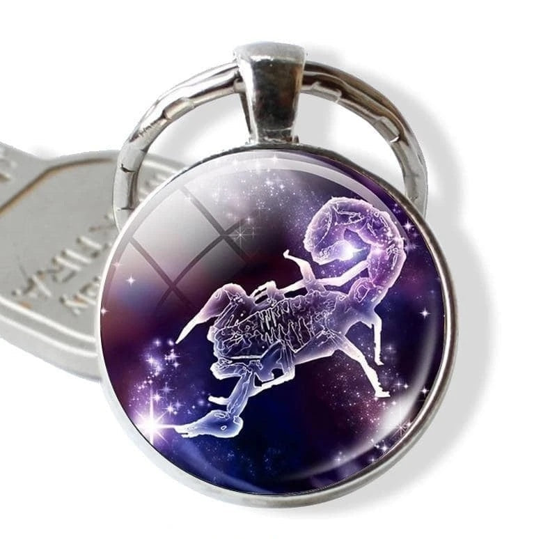 Keychain with a zodiac sign design on a purple background
