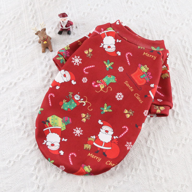 Red baby outfit with Christmas-themed design on a textured white background