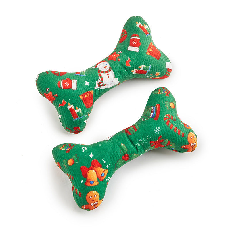 Two green bone-shaped Christmas-themed dog toys on a white background