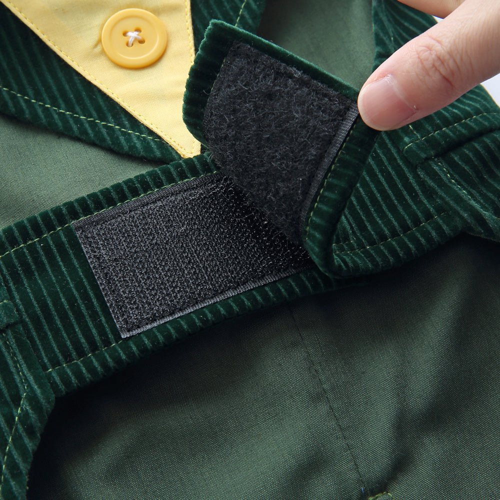 Close-up of a green jacket with a black patch and a hand adjusting it.