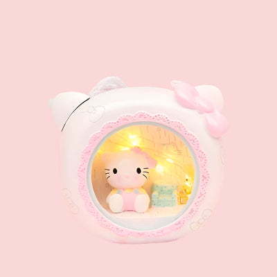 Cute plush toy with a light-up display on a soft pink background