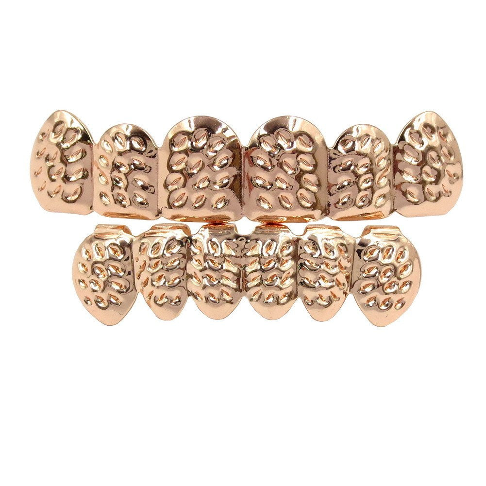 Rose gold teeth grill on a white background
