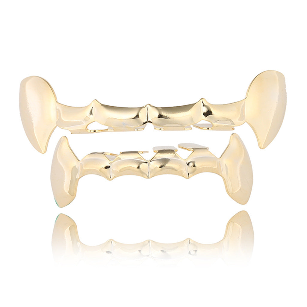 Gold bat-shaped grill on a white background