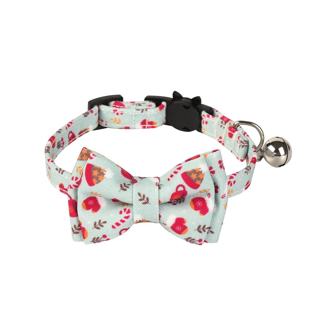 Floral patterned dog collar with bow tie and bell on a white background