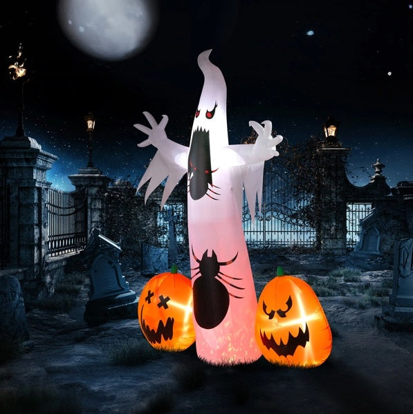 Inflatable ghost with spider decorations between two jack-o'-lanterns in a graveyard setting.