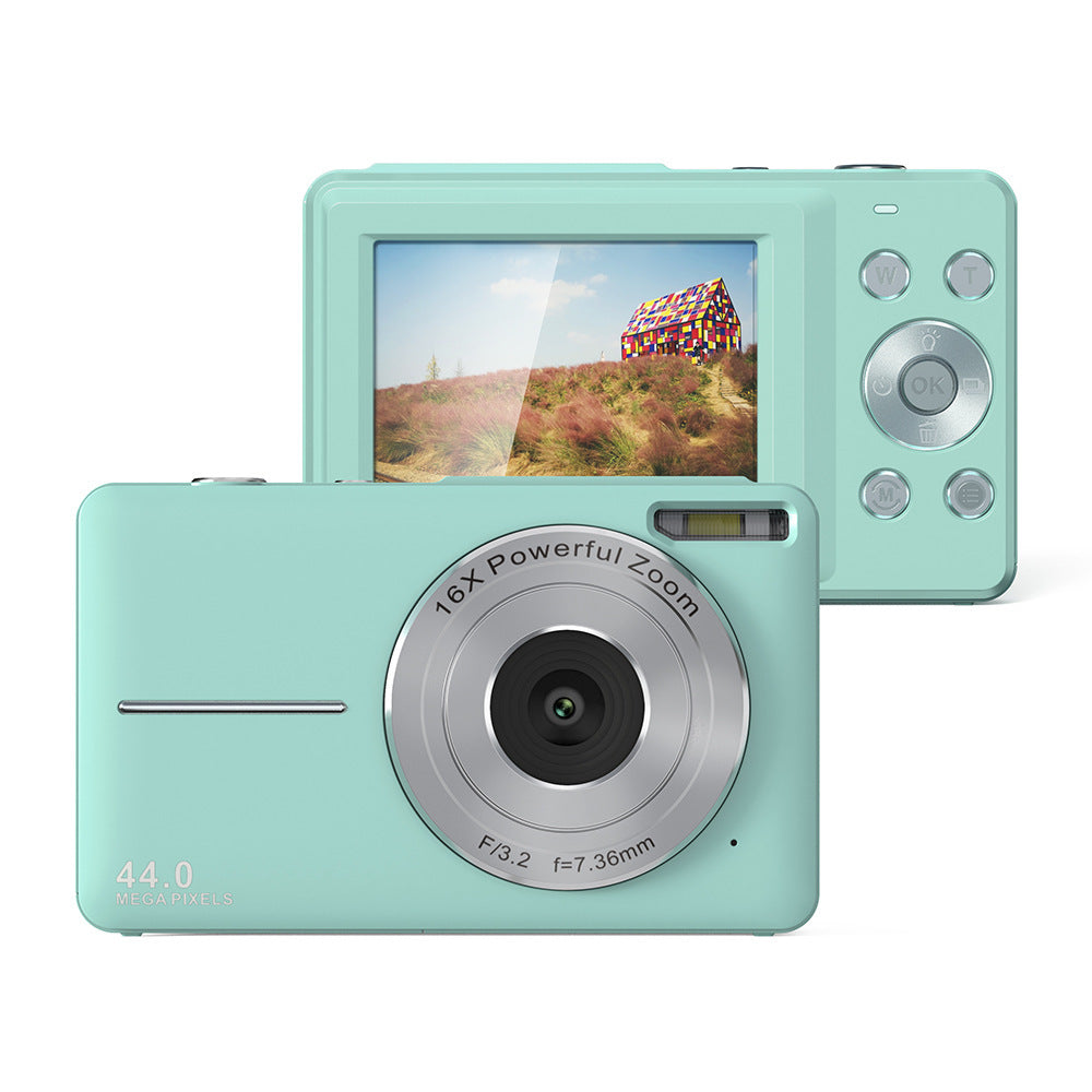 Mint green digital camera with screen displaying a colorful house on a white background