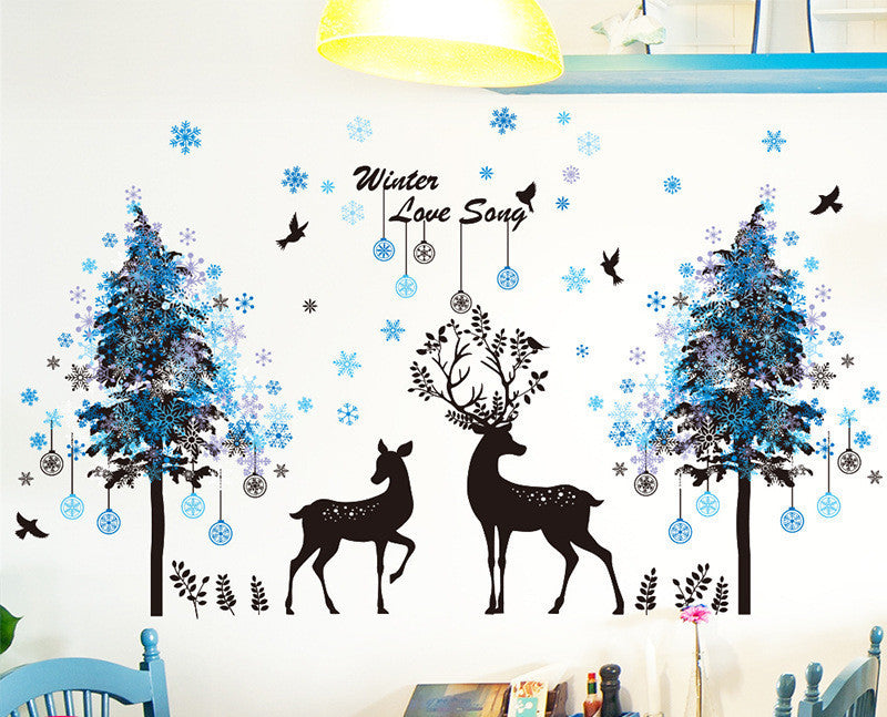 Wall decal with deer, trees, and snowflakes on a wall.
