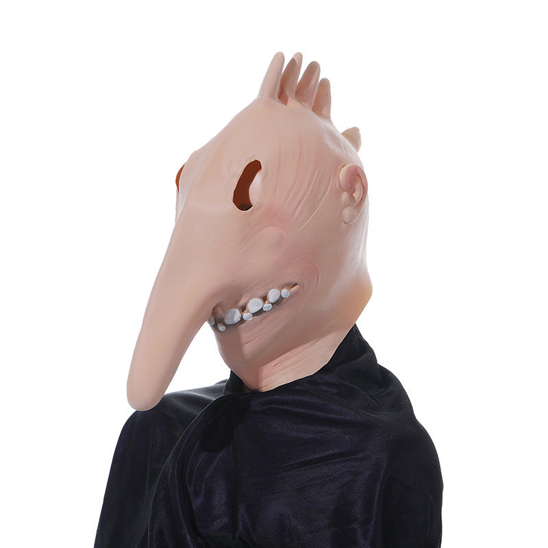 Person wearing a mask with a long nose and black outfit on a white background