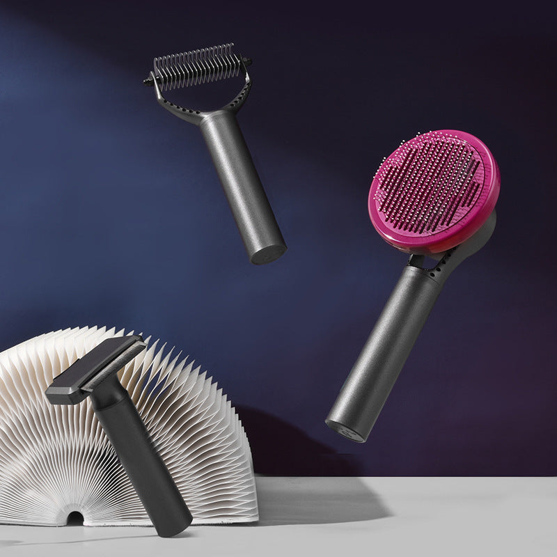 Set of grooming tools including a black razor, a gray and pink brush, and a white and black brush on a dark background.