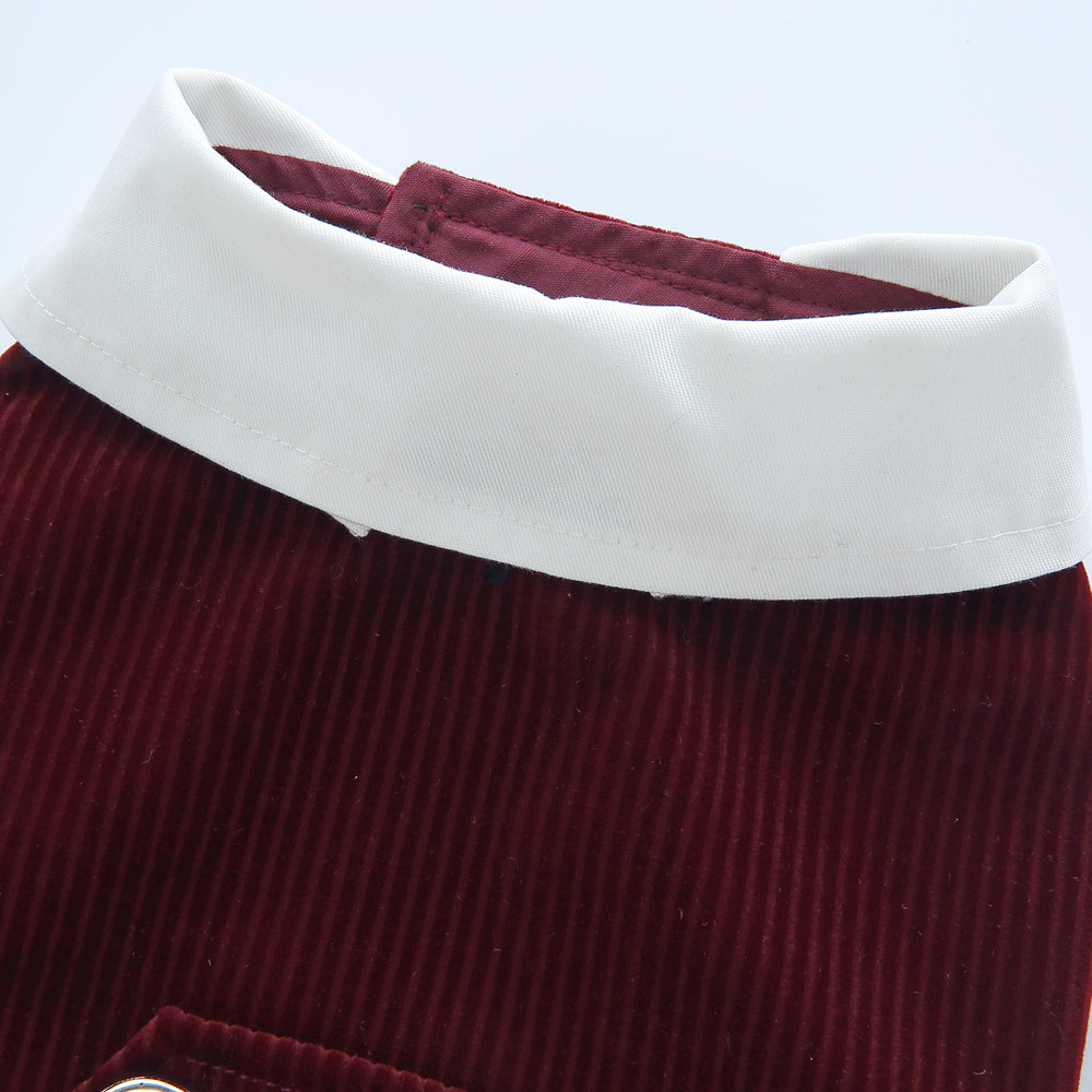 Close-up of a maroon corduroy skirt with a white collar on a light gray background