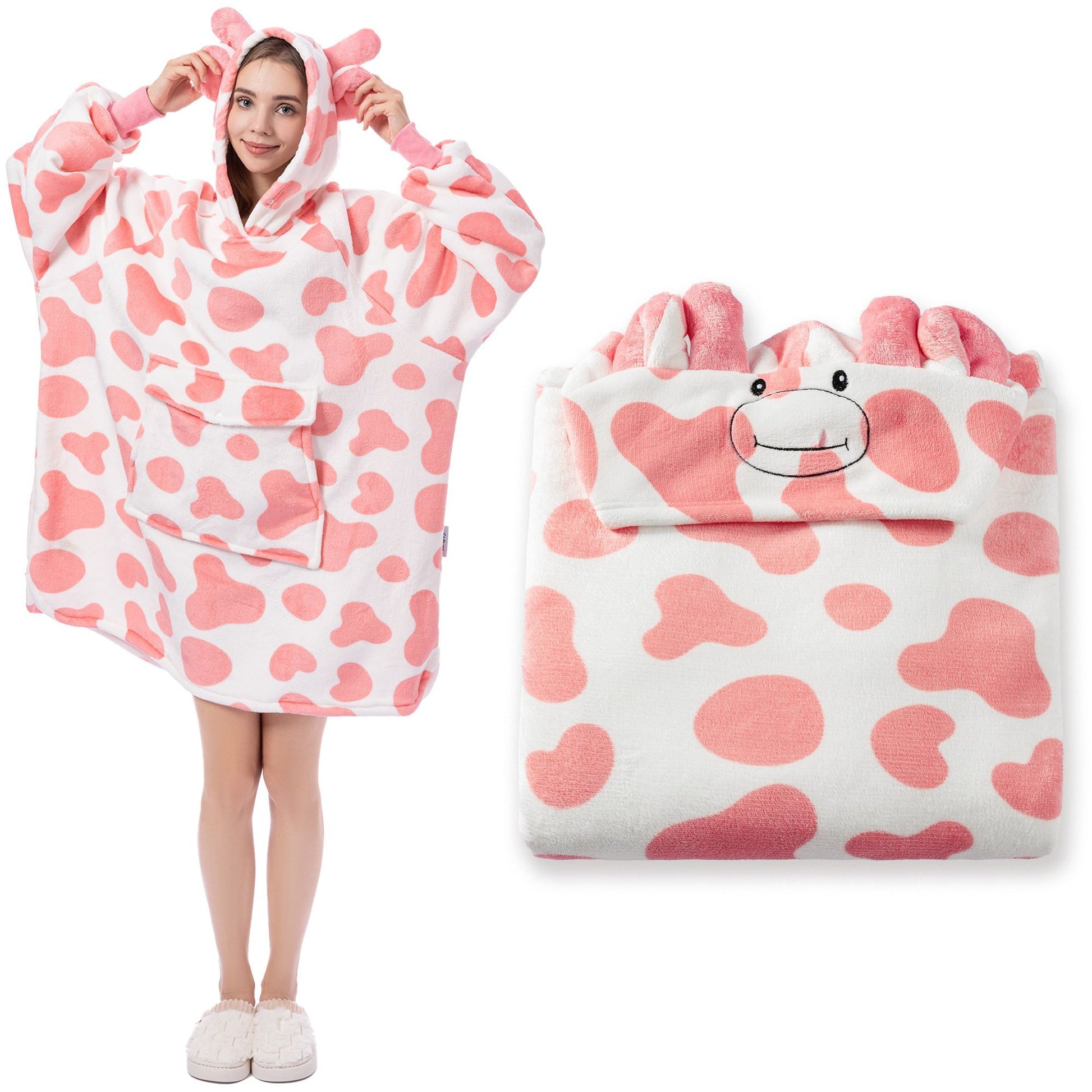 Pink and white cow-patterned poncho with a cartoon face on a white background