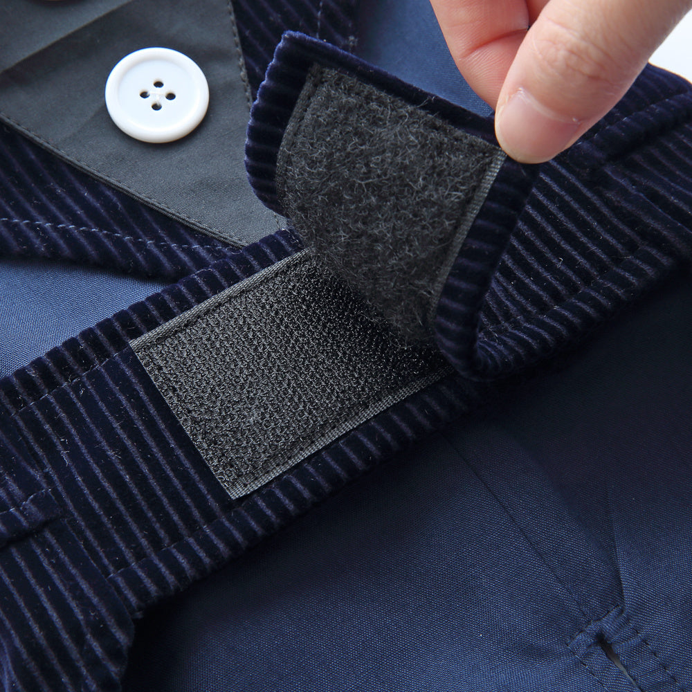 Navy blue corduroy fabric with a button and label