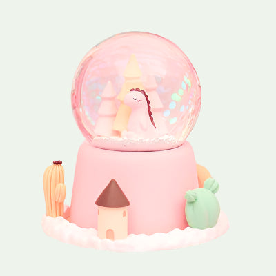 Decorative snow globe with a unicorn on a pink background