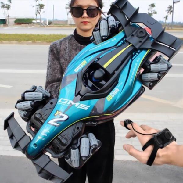 Person holding a large, futuristic-looking toy gun on a road.