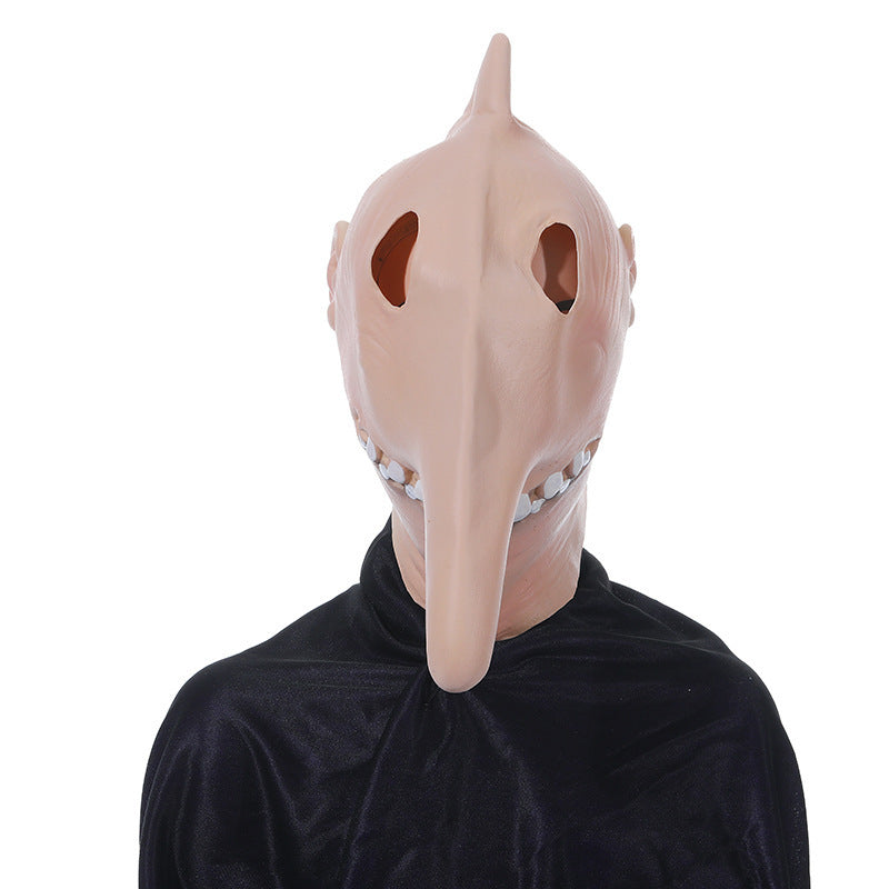 Person wearing a beige bird-like mask with a long beak on a white background