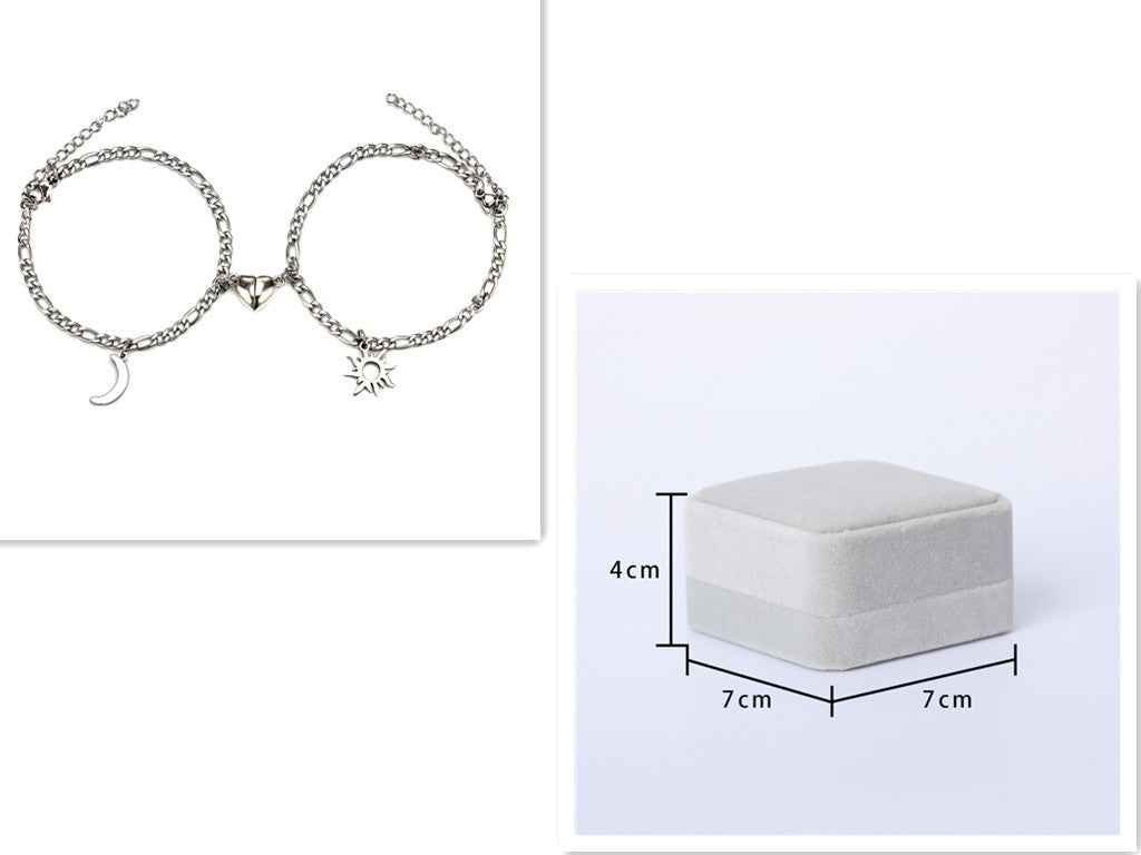 Silver bracelet with charms on a white background, next to a white jewelry box with dimensions.